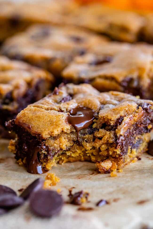 a bite taken out of the corner of a pumpkin chocolate chip bar.