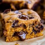 a slice of pumpkin blondies with chocolate oozing out the side