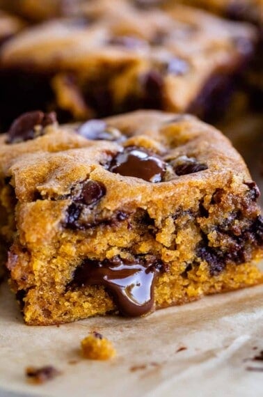 a slice of pumpkin blondies with chocolate oozing out the side