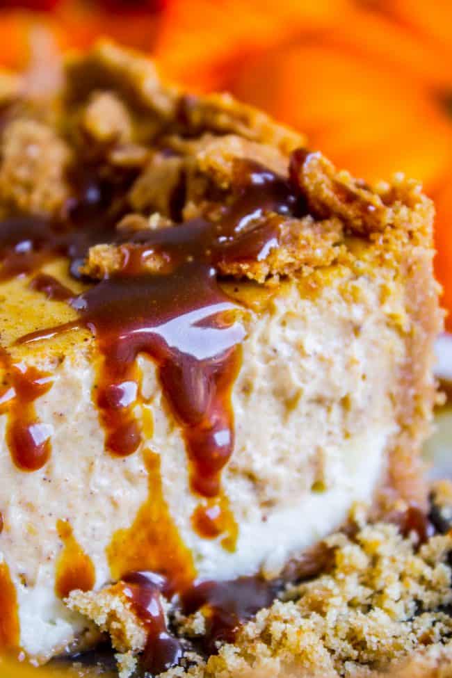 pumpkin cheesecake with caramel sauce shot from the side.