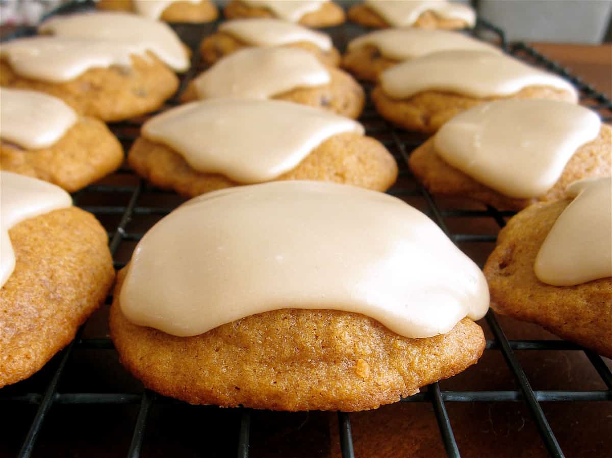 Soft Pumpkin Cookies with Brown Butter Icing from The Food Charlatan. These Soft Pumpkin Cookies taste like they came straight from a bakery! A super soft, fluffy, and THICK pumpkin cookie that just melts in your mouth, topped with a browned butter icing that will knock your socks off. You will want to eat about a thousand of these! #pumpkin #cookies #fall #pumpkincookies #easy #recipe #oldfashioned #cakey #icing #soft #glaze #frosted #best #meltinyourmouth #halloween #Thanksgiving #Christmas soft pumpkin cookies
