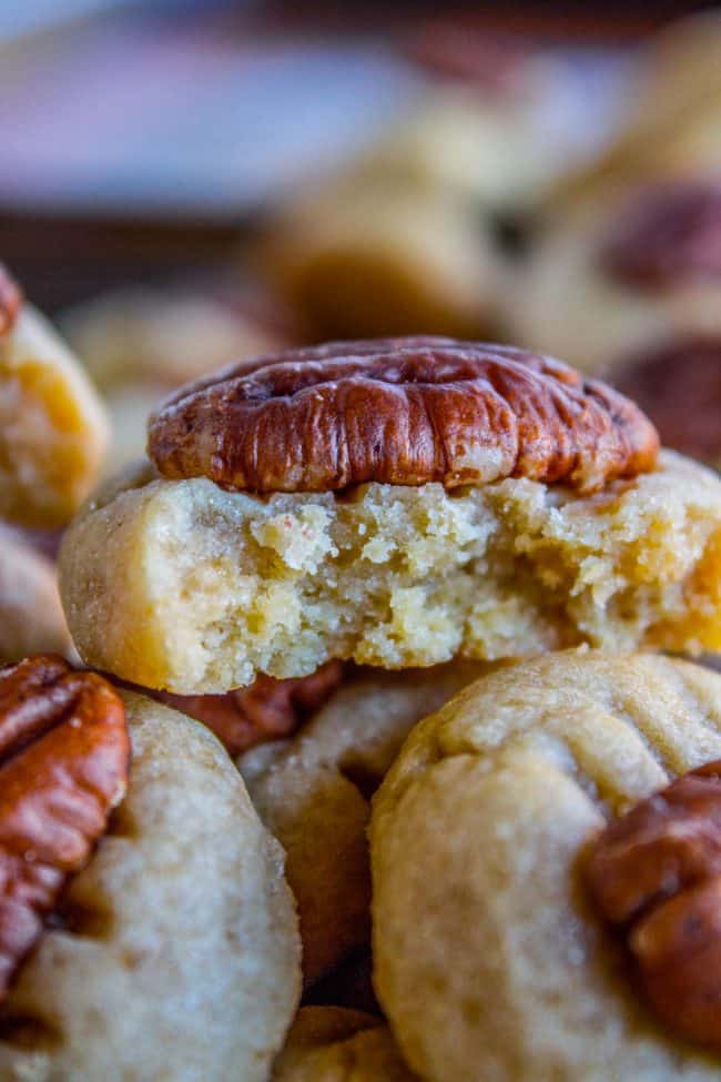 butter pecan cookies stacked with a bite out of the top one.