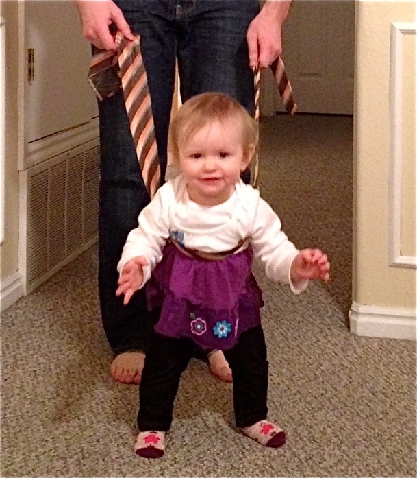 Char walking Baby walking with the help of a tie.