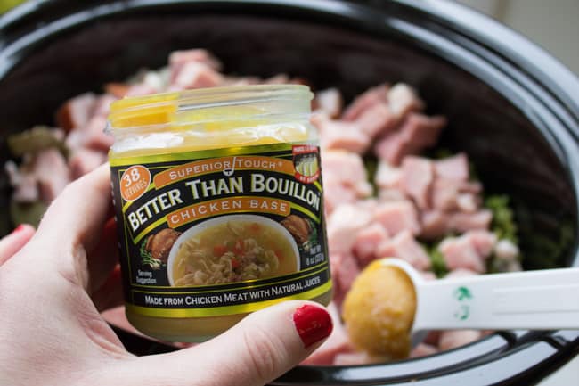 measuring Better than Bouillon Chicken Base into a crockpot.