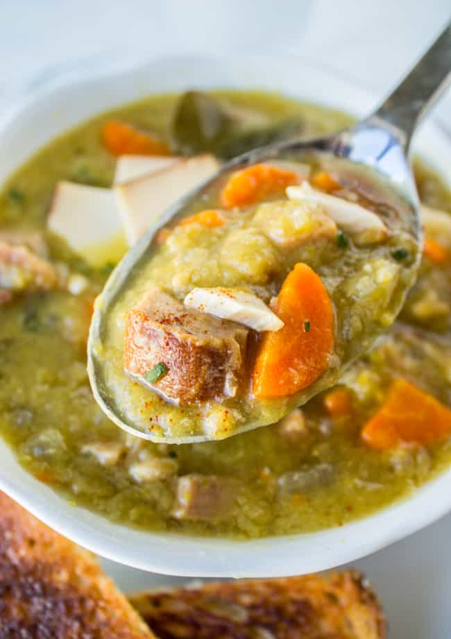 a spoon lifting a bite of split pea soup from the bowl.