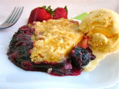 Easy Berry Cobbler on a plate with ice cream and strawberries