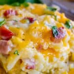hash brown egg casserole close up showing cheese, egg, potato, and chives for breakfast
