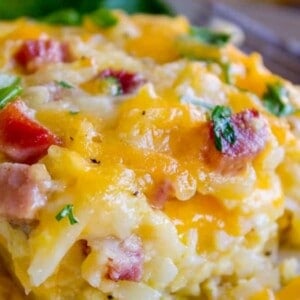 hash brown egg casserole close up showing cheese, egg, potato, and chives for breakfast