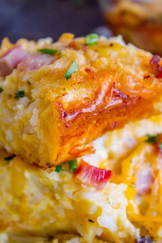 Cheesy Overnight Hashbrown Breakfast Casserole from The Food Charlatan. This Cheesy Hashbrown Breakfast Casserole is everything you need on Christmas morning! Hashbrowns are baked til crispy, then topped with eggs, cheese, and black forest ham. It's an overnight recipe to boot! Make ahead breakfasts ftw. #makeahead #cheese #breakfast #casserole #breakfastcasserole #easy #recipe #ham #blackforestham #Christmas #party #holildays #withhashbrowns #withpotatoes #overnight #makeahead #foracrowd #best easy breakfast casserole close up of crispy edge ready to be served as an individual portion.