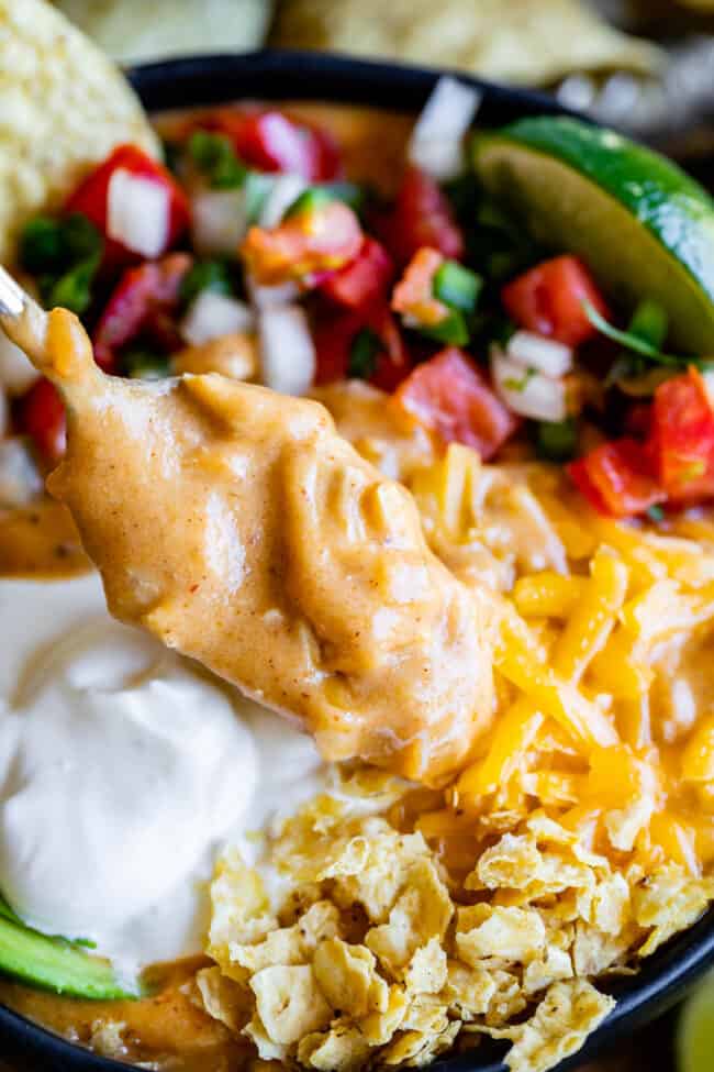 close up shot of a spoonful of chicken tortilla soup.