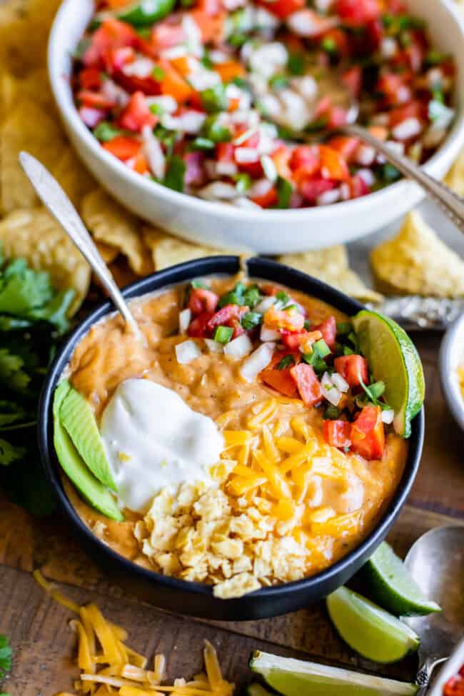 bowl of chicken enchilada soup in front of a bowl of pico de gallo.