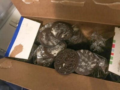 large box of oreos with filling licked out of them.
