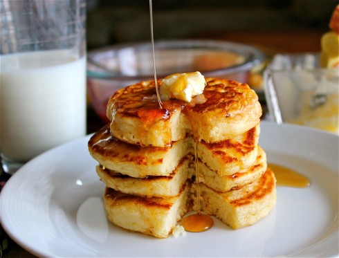 stack of pancakes with maple syrup and butter.
