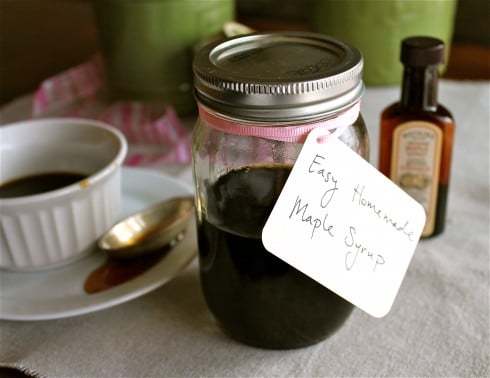 Maple syrup in a small mason jar with a pink bow and label. 