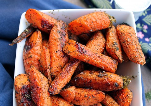 Roasted carrots and dill in a white dish.