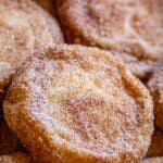 how to make snickerdoodles soft and chewy, stacked on a pan