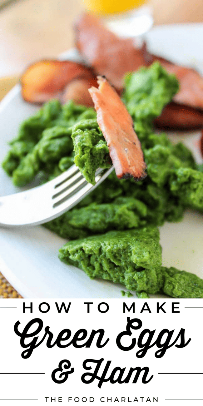 green eggs colored with spinach and ham on a white plate with a fork.