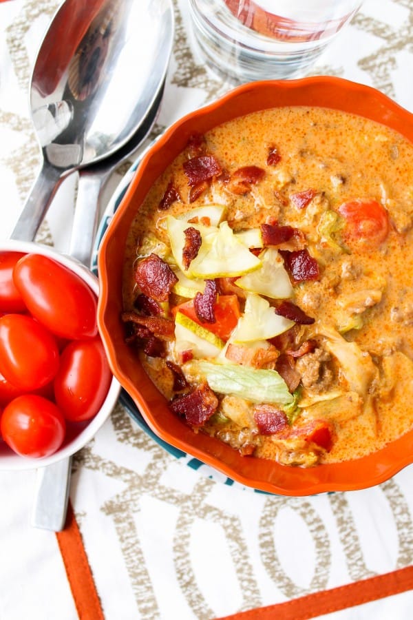 old photo of cheeseburger soup with cherry tomatoes nearby. 