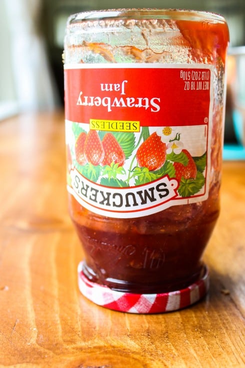 Jar of strawberry jam, upside down.