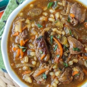 beef and barley soup in a white bowl.