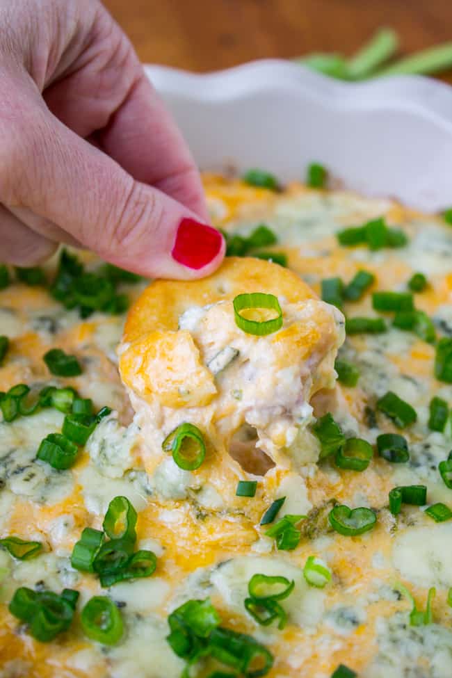Cracker in chicken dip with frank's hot sauce.