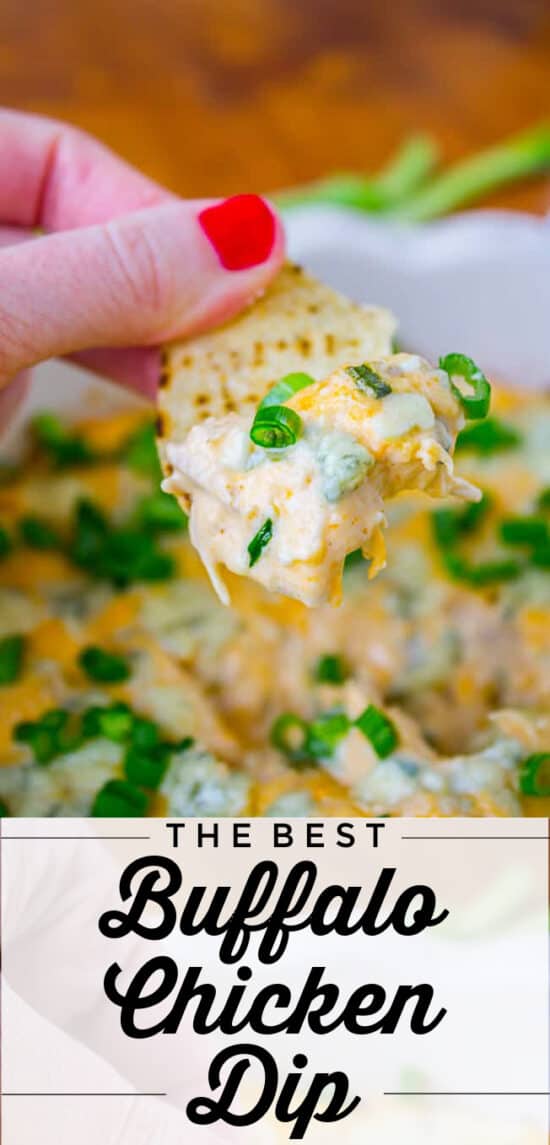 tortilla chip held in hand with cheesy buffalo chicken dip