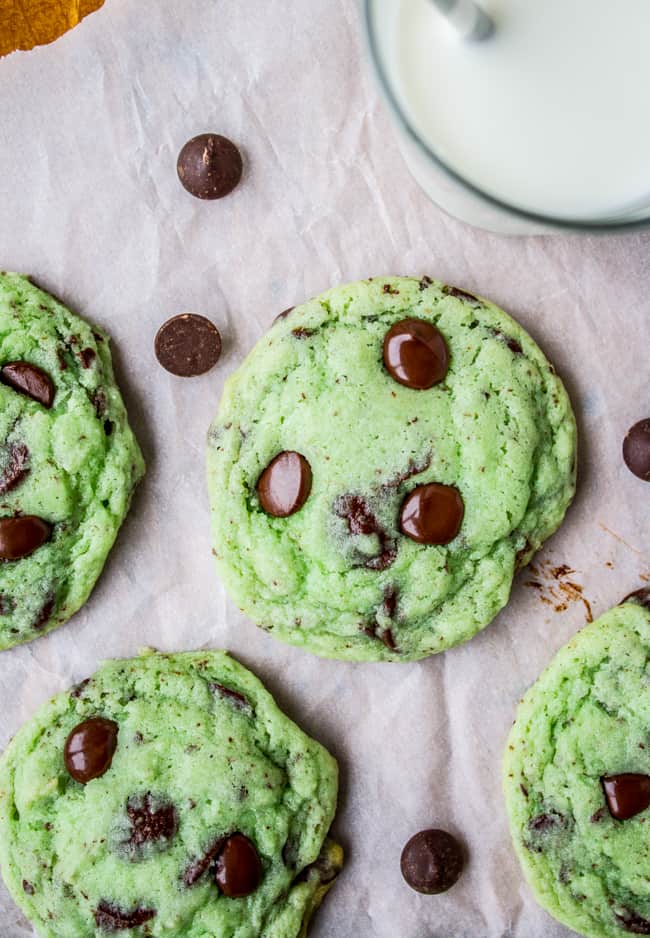 Mint Chocolate Chip Cookies from The Food Charlatan. These Mint Chocolate Chip Cookies are like eating the ice cream in the form of a warm, buttery, gooey cookie. They're crisp on the edges while perfectly tender and chewy in the center. #mint #chocolate #chip #cookies #peppermint #chocolatechip #gooey #chewy #easy #recipe #crisp Mint chocolate chip cookies with melted chocolate chips shot from overhead