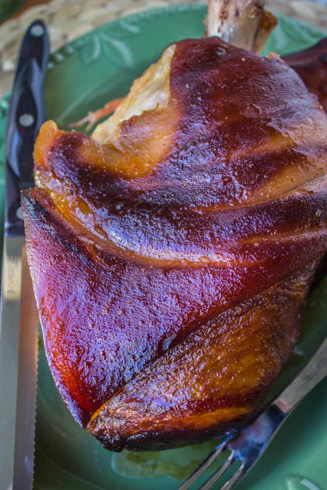 slow cooked sriracha ham on a teal plate with a fork.