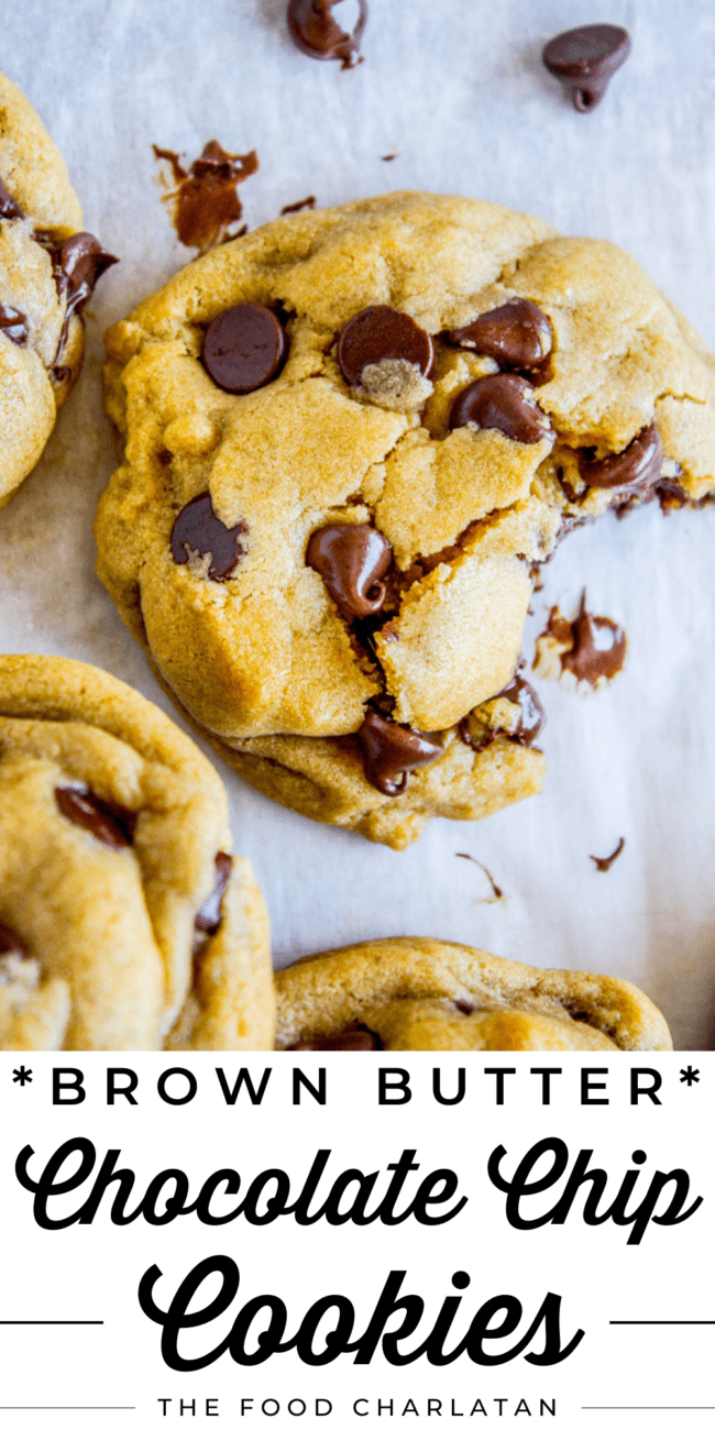 a chocolate chip cookie with a large bite taken out of it on parchment paper.