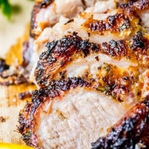 Cuban Mojo Marinated Pork sliced on a cutting board.