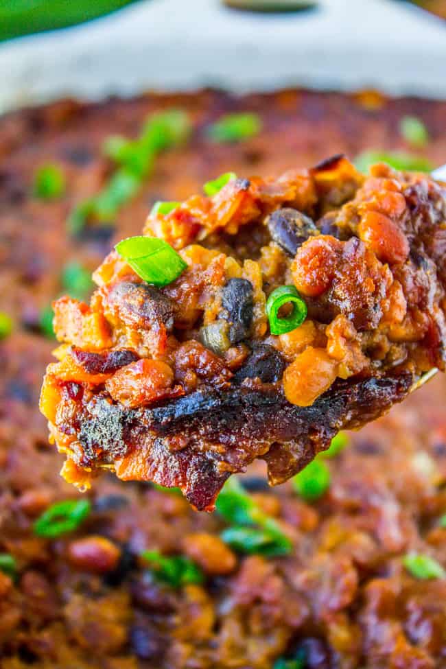 a serving spoon full of bacon baked beans.
