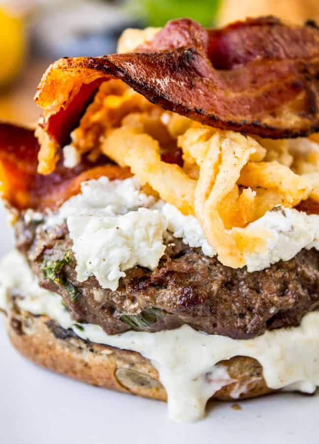 Bacon and Goat Cheese Aioli Burger with Crispy Onions from The Food Charlatan. This juicy lemon aioli burger is topped with goat cheese, bacon, crispy onion strings, and a killer bun. It's a gourmet burger recipe that's perfect for any summer grilling get-togethers! #burger #aioli #grill #bacon #crispyonions #goatcheese #hamburgerbun #daveskillerbread #summer Bacon Burger Recipe