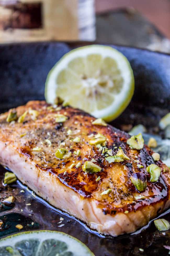 Salmon with pistachios and lemon in a cast iron skillet. 
