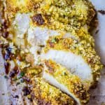 sliced breaded chicken on parchment paper.