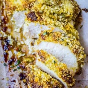sliced breaded chicken on parchment paper.