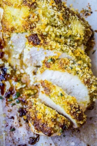 sliced breaded chicken on parchment paper.