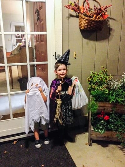 Kids dressed as a ghost and witch for Halloween. 