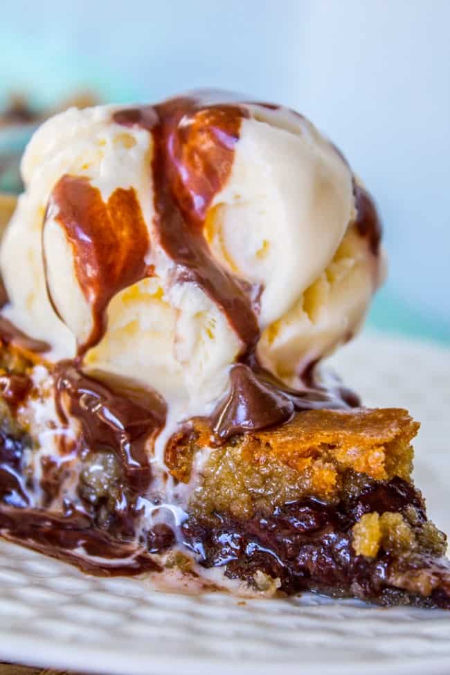 Chocolate Chip Cookie Pie with vanilla ice cream on a white plate. 