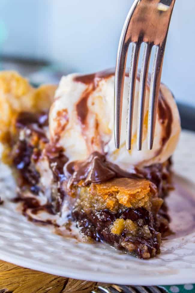 A fork and a slice of Toll House Cookie Pie on a white plate. 