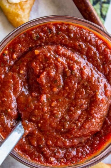 pizza sauce in a jar with a spoon.