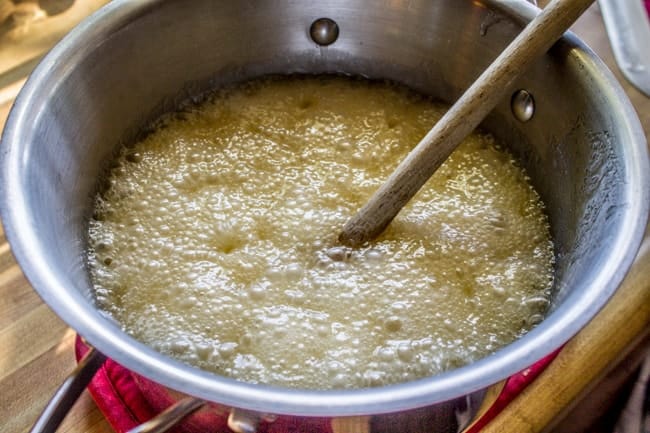 How to make sweet and salty chex mix recipe showing melted butter boiling.