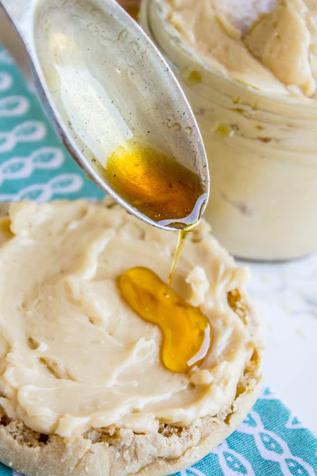 Spoon drizzling maple syrup onto butter. 