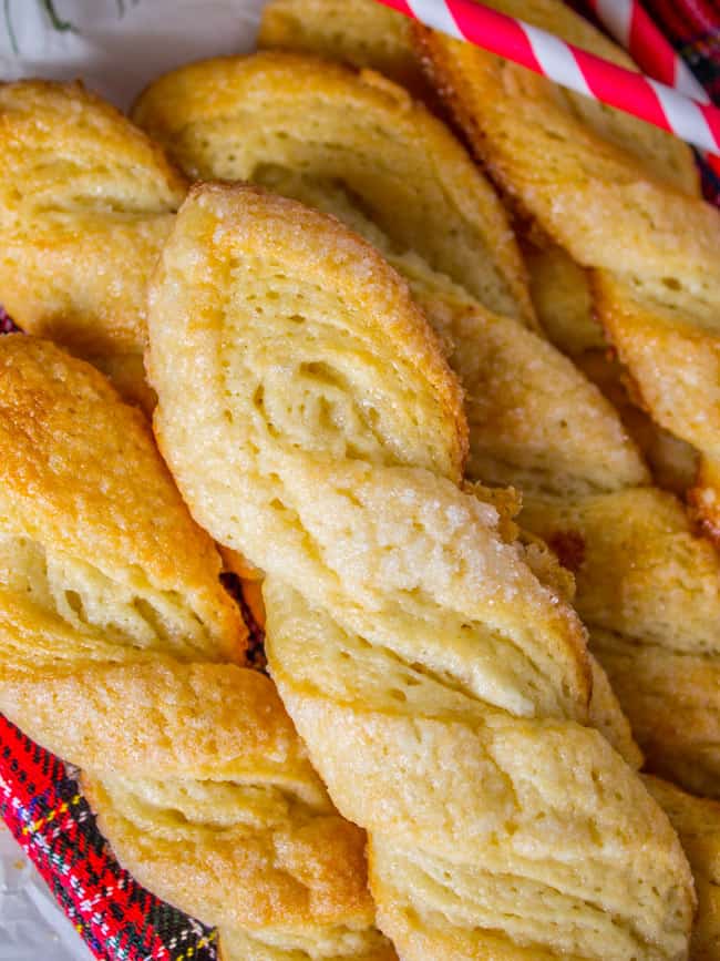 A basket full of baked sugary twist cookies.