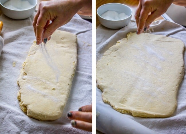 rolled out dough being sprinkled by hand with sugar. 