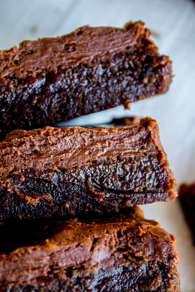 a stack of frosted fudge brownies.