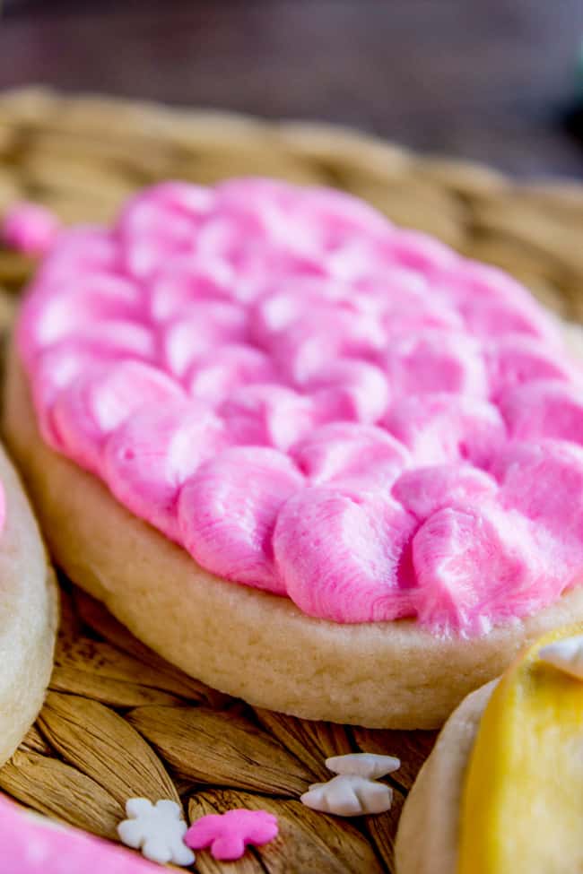 Buttercream frosting for cookies in decorative scallops on top of a soft sugar cookie.