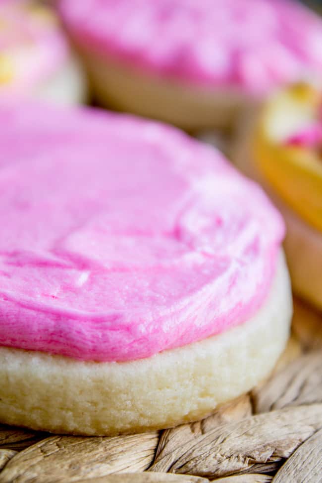 Pink cookie frosting on top of sugar cookie.