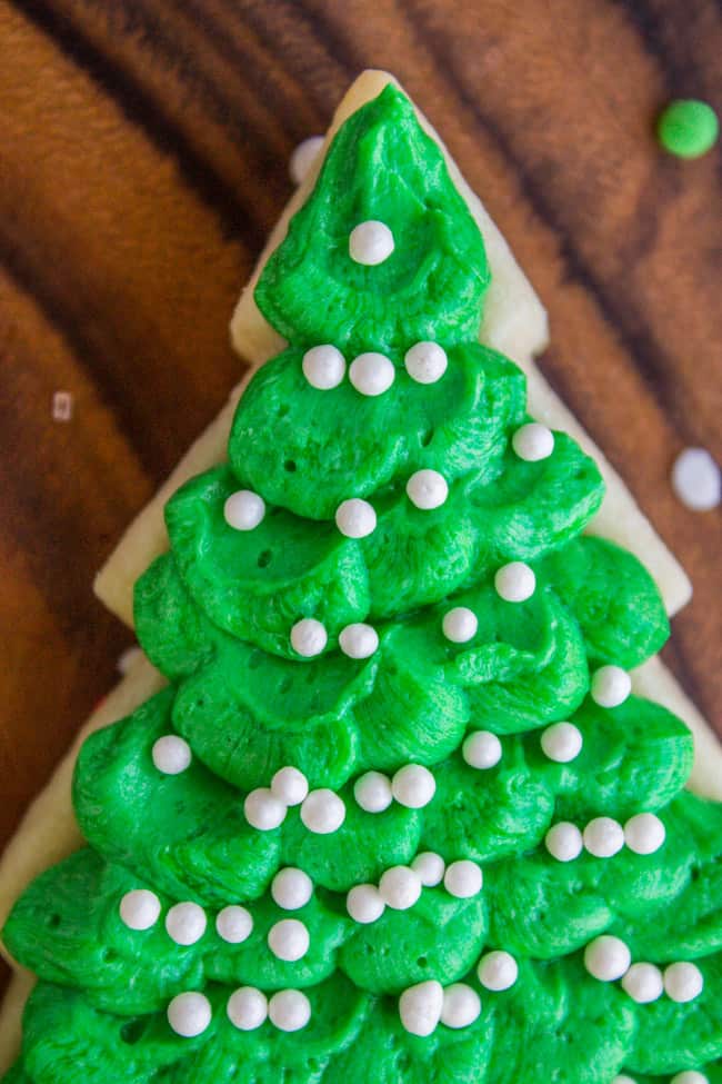 Green sugar cookie frosting on top of a Christmas tree shaped cookie.