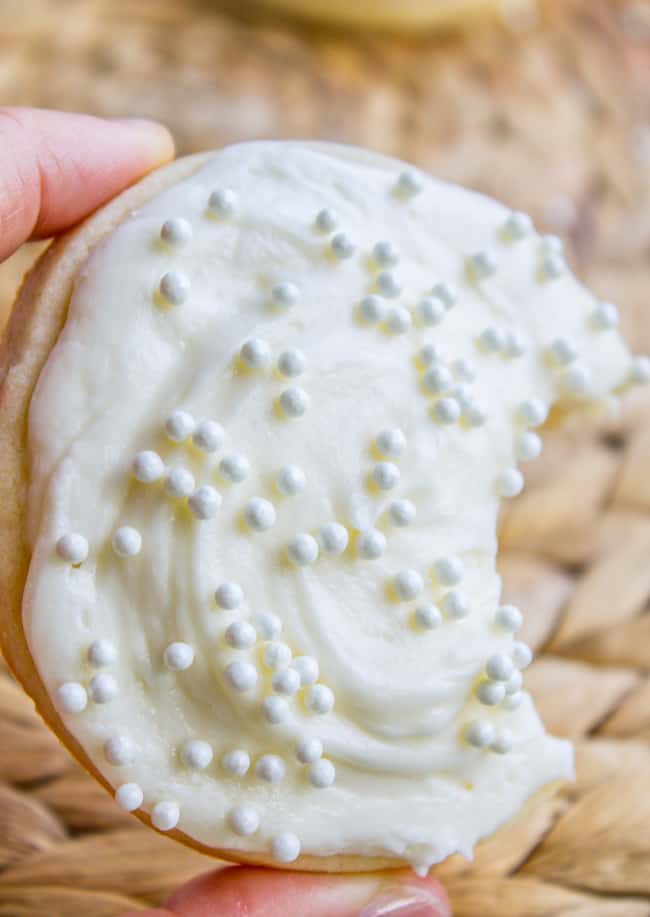 Sugar cookie decorated with white frosting for sugar cookie and sprinkles.