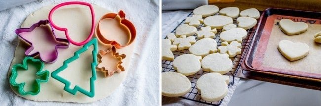 Sugar cookie dough rolled out with 5 cookie cutouts on top in various holiday shapes next to a pan of freshly baked Valentine's and Christmas cookies.
